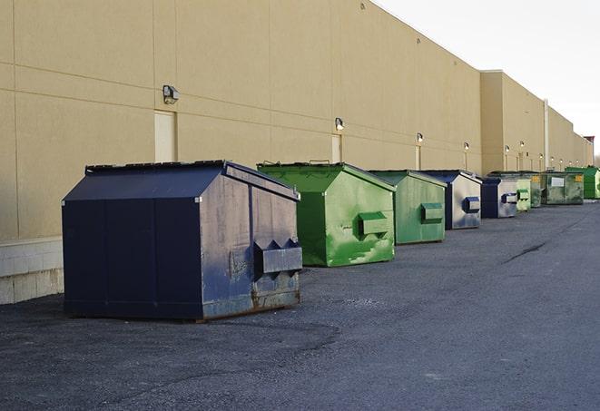 a fleet of red and blue construction dumpsters available for use in Decatur, MI